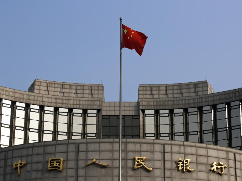 A Chinese national flag flutters in front of the People's Bank of China, the country's central bank, in Beijing. The bank plans to launch a cryptocurrency. A Chinese national flag flutters in front of the People's Bank of China, the country's central bank, in Beijing. The bank plans to launch a cryptocurrency.