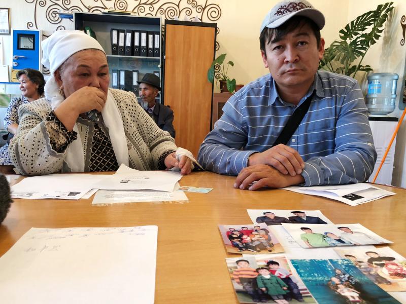 Kalida Akytkhan, pictured with her son Parkhat Rakhymbergen, has two sons and two daughter-in-laws who have been detained in re-education camps in Xinjiang. She brought photos of her family to the offices of rights organization Atazhurt in Almaty. Kalida Akytkhan, pictured with her son Parkhat Rakhymbergen, has two sons and two daughter-in-laws who have been detained in re-education camps in Xinjiang. She brought photos of her family to the offices of rights organization Atazhurt in Almaty.