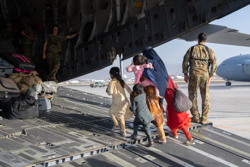 A family enters a U.S. Air Force plane in Kabul, Afghanistan, on Aug. 24, 2021. The evacuation was part of a U.S. effort to relocate Afghans to safety in the wake of the Taliban siege. But many families were separated in the process — and reuniting them A family enters a U.S. Air Force plane in Kabul, Afghanistan, on Aug. 24, 2021. The evacuation was part of a U.S. effort to relocate Afghans to safety in the wake of the Taliban siege. But many families were separated in the process — and reuniting them