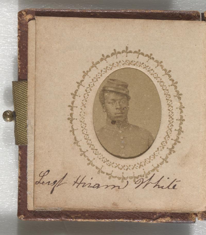 A yellowish brown photograph of Sgt. Hiram White. Sgt. White is wearing a buttoned-up jacket and a kepi in the portrait. He is leaning to his right and his kepi is on the left side of his head. His name is inscribed below the photograph on the same page. A yellowish brown photograph of Sgt. Hiram White. Sgt. White is wearing a buttoned-up jacket and a kepi in the portrait. He is leaning to his right and his kepi is on the left side of his head. His name is inscribed below the photograph on the same page.