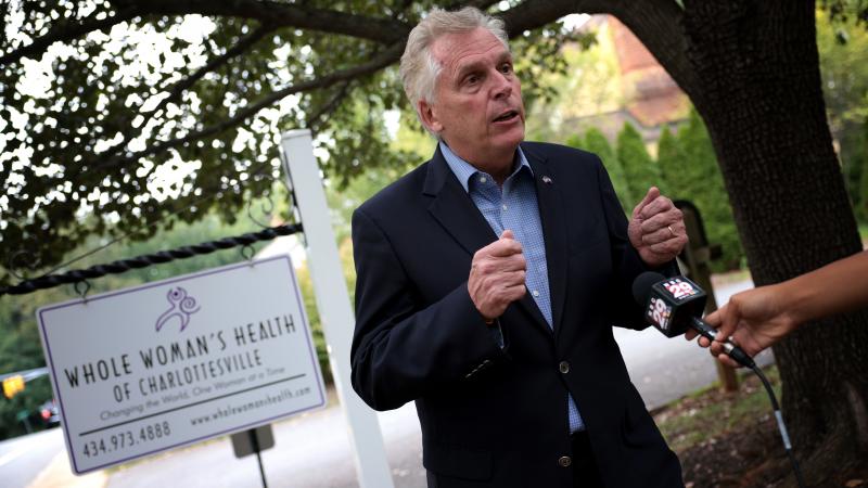Former Virginia Gov. Terry McAuliffe, a Democrat running for a second term, answers questions from the media after touring Whole Woman's Health of Charlottesville on Sept. 9. He's working to rally voters in response to Texas' restrictive new abortion law. Former Virginia Gov. Terry McAuliffe, a Democrat running for a second term, answers questions from the media after touring Whole Woman's Health of Charlottesville on Sept. 9. He's working to rally voters in response to Texas' restrictive new abortion law.
