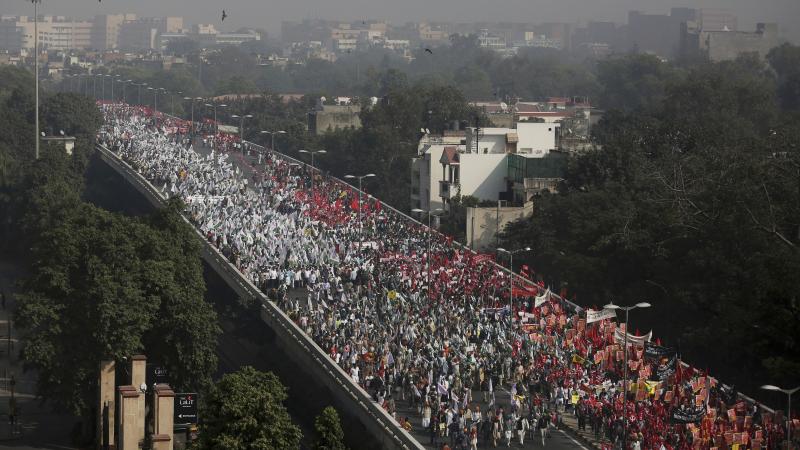 Indian farmers and agricultural laborers march towards the Indian Parliament during a protest rally in New Delhi, India, on Friday. Indian farmers and agricultural laborers march towards the Indian Parliament during a protest rally in New Delhi, India, on Friday.