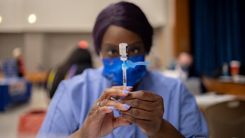 A health care worker prepares a dose of the Pfizer-BioNTech COVID-19 vaccine last week at West Philadelphia High School in Philadelphia. Dr. Anthony Fauci says he backs mandatory vaccines for teachers, citing a "critical situation" in the country. A health care worker prepares a dose of the Pfizer-BioNTech COVID-19 vaccine last week at West Philadelphia High School in Philadelphia. Dr. Anthony Fauci says he backs mandatory vaccines for teachers, citing a "critical situation" in the country.