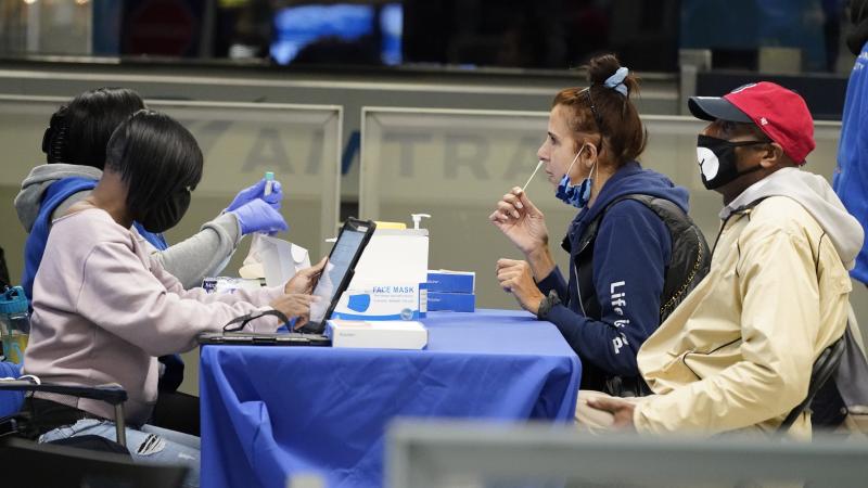 Travelers self-test for the coronavirus at a mobile testing site at New York City's Penn Station in the days leading up to Thanksgiving. The U.S. is currently seeing record hospitalizations for COVID-19, and health experts fear more surges are on their wa Travelers self-test for the coronavirus at a mobile testing site at New York City's Penn Station in the days leading up to Thanksgiving. The U.S. is currently seeing record hospitalizations for COVID-19, and health experts fear more surges are on their wa