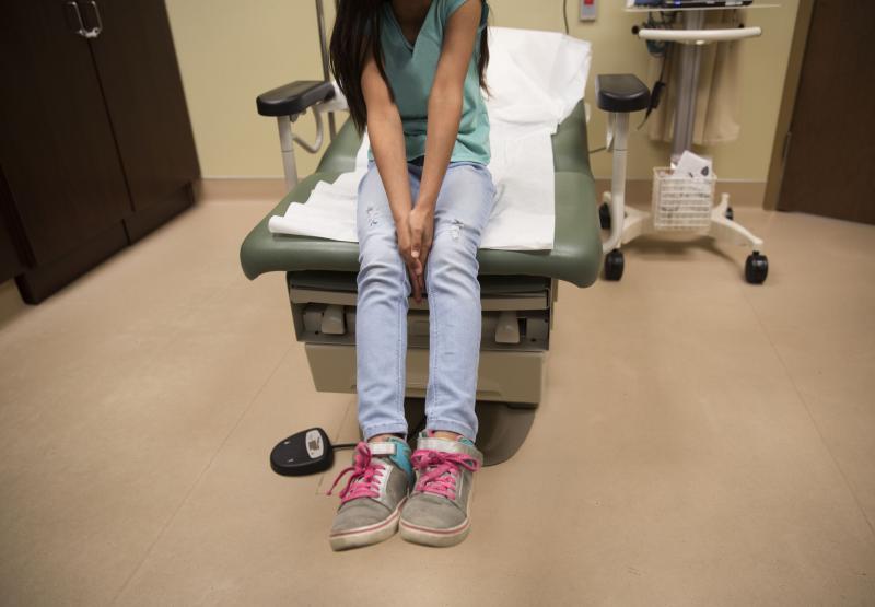 A young girl waits for care in a medical clinic. A growing number of citizen children of immigrant parents are losing out on Medicaid because their parents fear deportation. A young girl waits for care in a medical clinic. A growing number of citizen children of immigrant parents are losing out on Medicaid because their parents fear deportation.