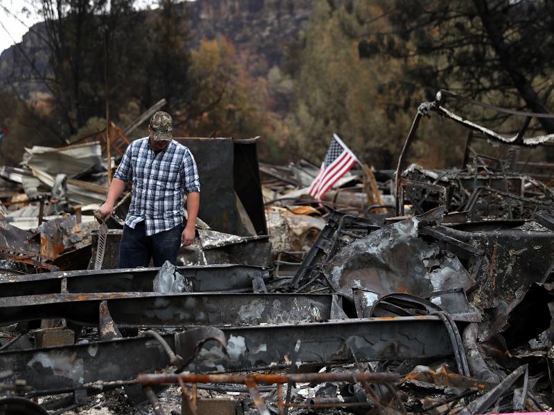 Noah Fisher looks over his home that was destroyed by the Camp Fire in November 2018 in Paradise, California. Investigators are examining whether PG&E power lines helped ignite the fire. Noah Fisher looks over his home that was destroyed by the Camp Fire in November 2018 in Paradise, California. Investigators are examining whether PG&E power lines helped ignite the fire.