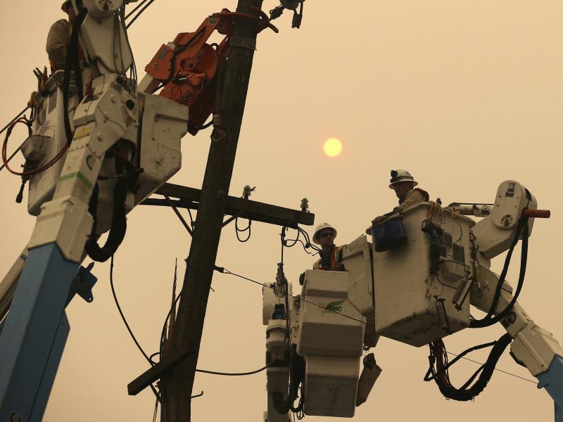 PG&E crews work to restore power lines in Paradise, Calif., after the Camp Fire destroyed much of the Northern California town. PG&E crews work to restore power lines in Paradise, Calif., after the Camp Fire destroyed much of the Northern California town.