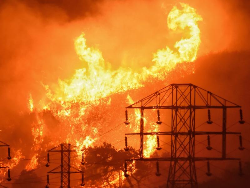 Flames burn near power lines in Montecito, Calif. State fire officials say power lines coming into contact with trees sparked four Northern California wildfires last October. Flames burn near power lines in Montecito, Calif. State fire officials say power lines coming into contact with trees sparked four Northern California wildfires last October.