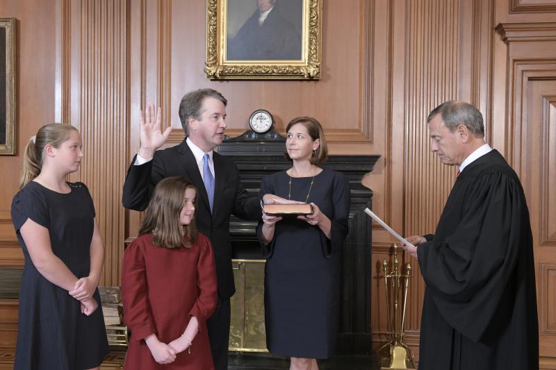 Chief Justice John Roberts administers the constitutional oath to Judge Brett M. Kavanaugh as his wife, Ashley Kavanaugh, holds the Bible. They're accompanied by their daughters, Margaret and Liza. Chief Justice John Roberts administers the constitutional oath to Judge Brett M. Kavanaugh as his wife, Ashley Kavanaugh, holds the Bible. They're accompanied by their daughters, Margaret and Liza.
