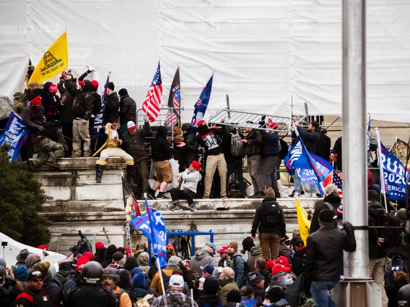 Pro-Trump extremists climb the walls of the U.S. Capitol on Jan. 6. The pro-Trump mob broke windows of the Capitol and clashed with police officers. Now there's debate about whether federal charges of seditious conspiracy should be used against some of th Pro-Trump extremists climb the walls of the U.S. Capitol on Jan. 6. The pro-Trump mob broke windows of the Capitol and clashed with police officers. Now there's debate about whether federal charges of seditious conspiracy should be used against some of th