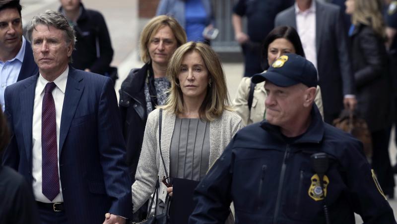 Felicity Huffman, center, departs federal court with her brother Moore Huffman Jr., left, Monday, May 13, 2019, in Boston, where she pleaded guilty to charges in a nationwide college admissions bribery scandal. Felicity Huffman, center, departs federal court with her brother Moore Huffman Jr., left, Monday, May 13, 2019, in Boston, where she pleaded guilty to charges in a nationwide college admissions bribery scandal.