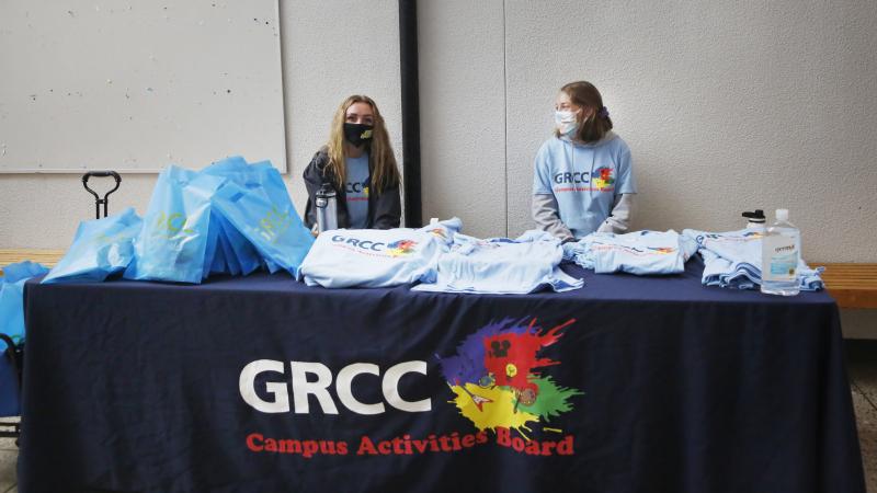 Students at Grand Rapids Community College pass out T-shirts to promote virtual student life offerings during the fall semester. Students at Grand Rapids Community College pass out T-shirts to promote virtual student life offerings during the fall semester.