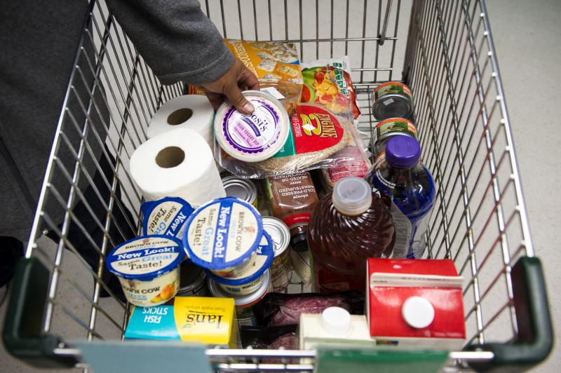 A food pantry client adds a carton of yogurt to her cart at the food pantry at Jewish Family Services in Denver, Colo. A food pantry client adds a carton of yogurt to her cart at the food pantry at Jewish Family Services in Denver, Colo.