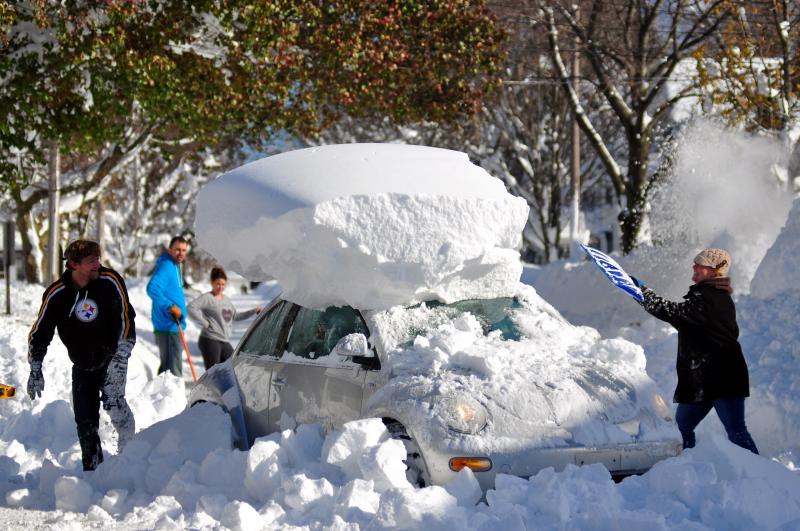 Michael Palmer and Carin Schultz work to clear her car of snow and remove it from Union street on Thursday in the Buffalo suburb of Hamburg. Michael Palmer and Carin Schultz work to clear her car of snow and remove it from Union street on Thursday in the Buffalo suburb of Hamburg.