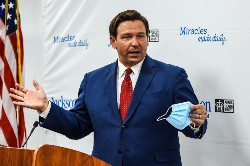 Florida Gov. Ron DeSantis speaks holding his facemask during a press conference to address the rise of coronavirus cases in the state, at Jackson Memorial Hospital in Miami, on July 13, 2020. Florida Gov. Ron DeSantis speaks holding his facemask during a press conference to address the rise of coronavirus cases in the state, at Jackson Memorial Hospital in Miami, on July 13, 2020.
