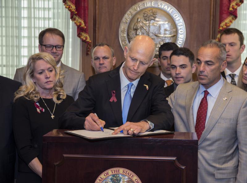 Florida Gov. Rick Scott signs the Marjory Stoneman Douglas Public Safety Act on Friday. The legislation includes a number of gun restrictions and also permits school personnel who are not full-time teachers to be armed. Florida Gov. Rick Scott signs the Marjory Stoneman Douglas Public Safety Act on Friday. The legislation includes a number of gun restrictions and also permits school personnel who are not full-time teachers to be armed.
