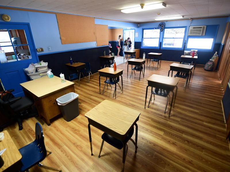 Children in an elementary school class wearing masks enter the classroom with desks spaced apart as per coronavirus guidelines in Monterey Park, Calif. Children in an elementary school class wearing masks enter the classroom with desks spaced apart as per coronavirus guidelines in Monterey Park, Calif.