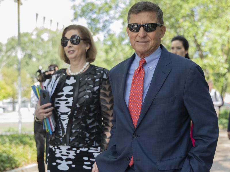 Michael Flynn, President Trump's former national security adviser, leaves federal court with lawyer Sidney Powell in September 2019. Michael Flynn, President Trump's former national security adviser, leaves federal court with lawyer Sidney Powell in September 2019.