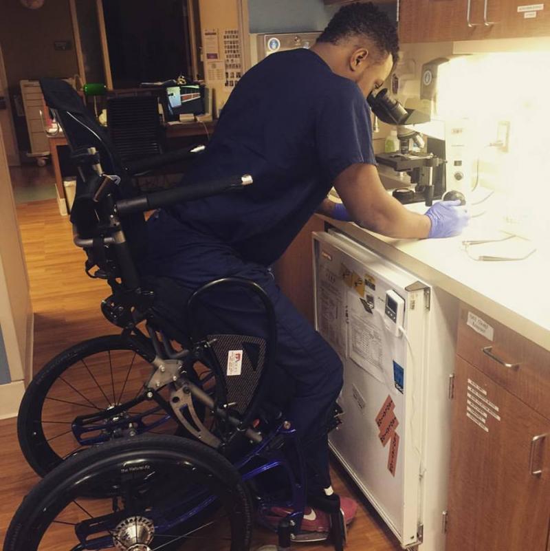 Feranmi Okanlami, now a doctor, became partially paralyzed after an accident in 2013. He says adjustments for his disability during his training, like this standing in frame chair, helped him succeed. A new report finds variability in medical institution Feranmi Okanlami, now a doctor, became partially paralyzed after an accident in 2013. He says adjustments for his disability during his training, like this standing in frame chair, helped him succeed. A new report finds variability in medical institution