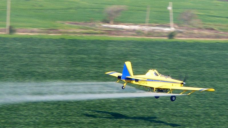 A pilot for Earl's Flying Service sprays chemicals on a field in southeastern Missouri. A pilot for Earl's Flying Service sprays chemicals on a field in southeastern Missouri.