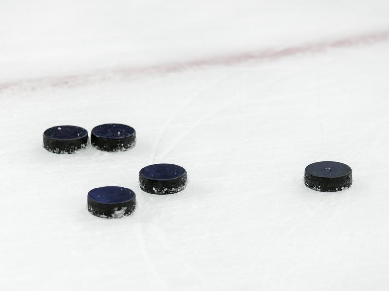 Hockey pucks on ice at Nationwide Arena in Columbus, Ohio. Hockey pucks on ice at Nationwide Arena in Columbus, Ohio.