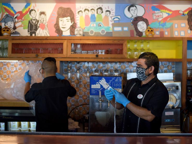 Workers prepare takeout orders May 1 in Houston. For more than two out of three unemployed workers, jobless benefits exceed their old pay, researchers say. That discrepancy can raise awkward questions for workers, bosses and policymakers. Workers prepare takeout orders May 1 in Houston. For more than two out of three unemployed workers, jobless benefits exceed their old pay, researchers say. That discrepancy can raise awkward questions for workers, bosses and policymakers.