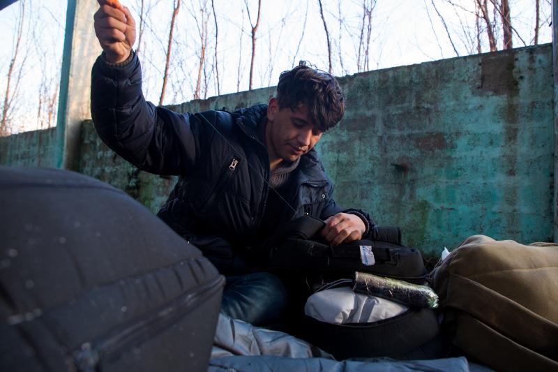 Afghan Morteza Mohammadi, 21, sews his backpack in the ruins of the former Krajina Metal factory. He prepares for an attempt to cross into European Union members Croatia, Slovenia and Italy. Migrants and refugees here refer to the trip as "the game." Afghan Morteza Mohammadi, 21, sews his backpack in the ruins of the former Krajina Metal factory. He prepares for an attempt to cross into European Union members Croatia, Slovenia and Italy. Migrants and refugees here refer to the trip as "the game."