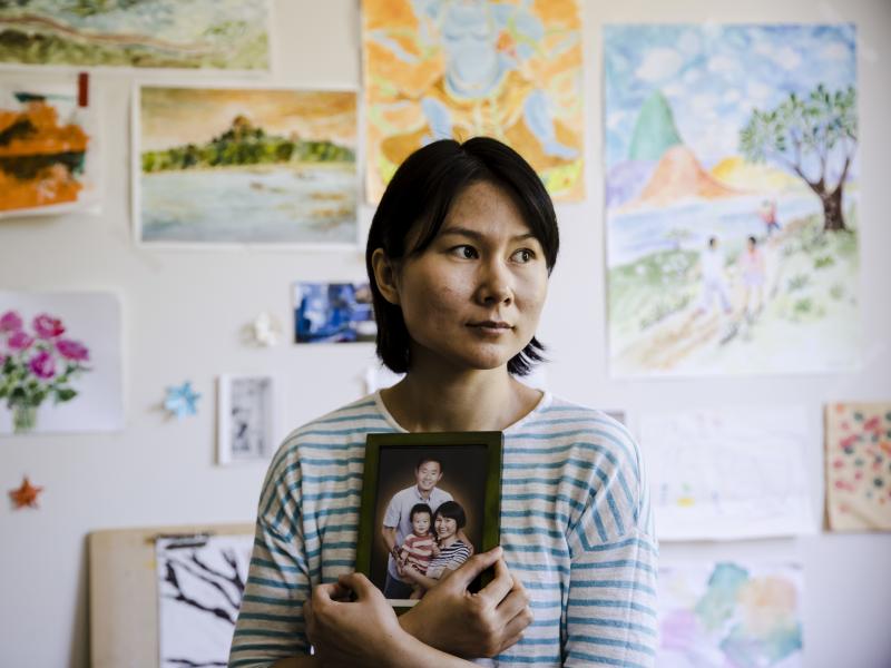 Hua Qu, the wife of Chinese-American Xiyue Wang, poses with a portrait of her family in Princeton, N.J., on May 9. Families of Americans detained in Iran are hoping President Trump's decision to withdraw from the Iran nuclear deal will not make it harder Hua Qu, the wife of Chinese-American Xiyue Wang, poses with a portrait of her family in Princeton, N.J., on May 9. Families of Americans detained in Iran are hoping President Trump's decision to withdraw from the Iran nuclear deal will not make it harder