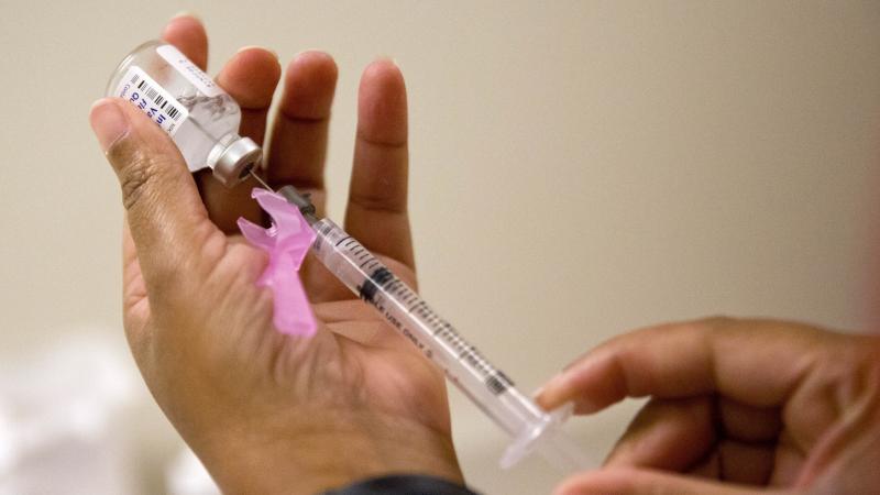 A nurse prepares a flu shot at the Salvation Army in Atlanta last month. The disease is still "widespread" in many places, but slowing. A nurse prepares a flu shot at the Salvation Army in Atlanta last month. The disease is still "widespread" in many places, but slowing.