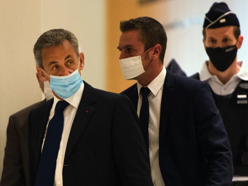 French former President Nicolas Sarkozy (left) arrives to hear the verdict in a corruption trial at Porte de Clichy court house in Paris on Monday. French former President Nicolas Sarkozy (left) arrives to hear the verdict in a corruption trial at Porte de Clichy court house in Paris on Monday.