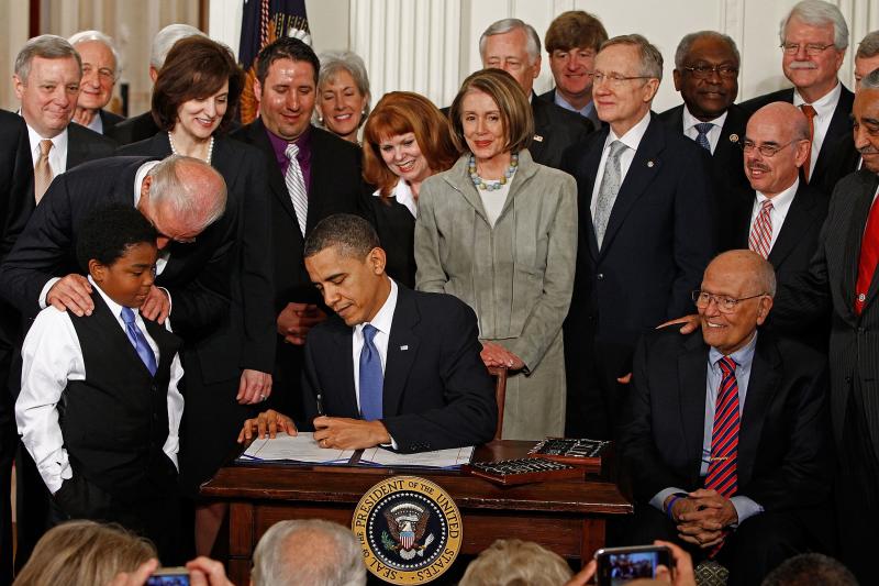 Rep. John Dingell was seated next to President Barack Obama when he signed the Affordable Care Act into law at the White House on March 23, 2010. Rep. John Dingell was seated next to President Barack Obama when he signed the Affordable Care Act into law at the White House on March 23, 2010.