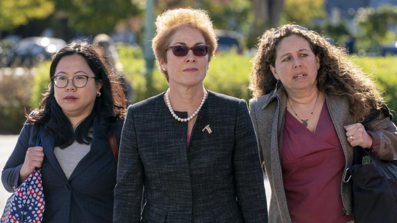 Former U.S. ambassador to Ukraine Marie Yovanovitch (center) arrives on Capitol Hill Friday for congressional testimony. Former U.S. ambassador to Ukraine Marie Yovanovitch (center) arrives on Capitol Hill Friday for congressional testimony.