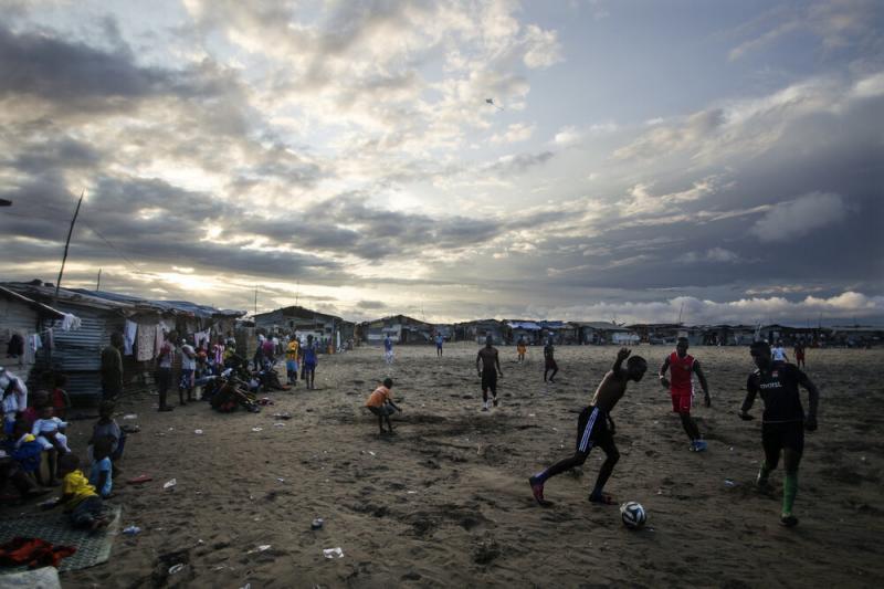 Thanksgiving is a day at the beach — quite literally — for young Liberians. Above, the beach in West Point is a sandy playing field for soccer lovers. Thanksgiving is a day at the beach — quite literally — for young Liberians. Above, the beach in West Point is a sandy playing field for soccer lovers.