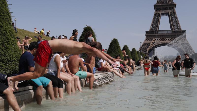 A boy jumps into the water of the Trocadero Fountain in Paris on Friday, to find relief from the heat wave. A boy jumps into the water of the Trocadero Fountain in Paris on Friday, to find relief from the heat wave.
