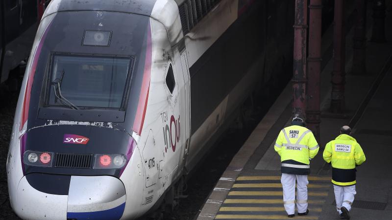 Emergency medical personnel walk by a high-speed TGV train in Strasbourg station on Wednesday, preparing to evacuate 20 COVID-19 patients to hospitals in western France. Emergency medical personnel walk by a high-speed TGV train in Strasbourg station on Wednesday, preparing to evacuate 20 COVID-19 patients to hospitals in western France.