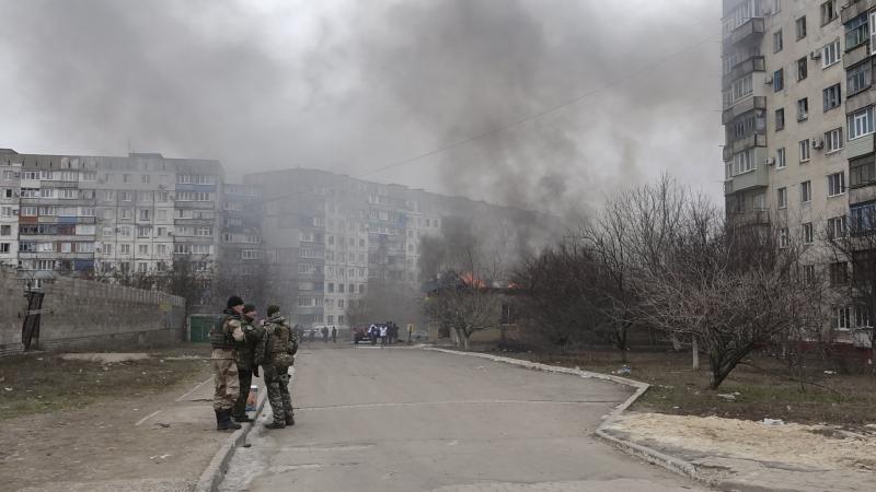 Ukrainian servicemen stand guard on a street near a burning building after a shelling by pro-Russian rebels of a residential sector in Mariupol, eastern Ukraine, last month. Ukrainian servicemen stand guard on a street near a burning building after a shelling by pro-Russian rebels of a residential sector in Mariupol, eastern Ukraine, last month.