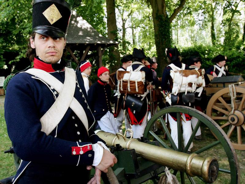 Belgium's plan to honor the Battle of Waterloo displeased France. In this photo, an enthusiast dressed as a member of the French army stands next to a cannon before the re-enactment of the famous battle. Belgium's plan to honor the Battle of Waterloo displeased France. In this photo, an enthusiast dressed as a member of the French army stands next to a cannon before the re-enactment of the famous battle.