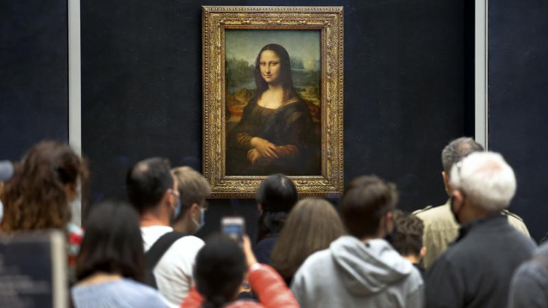 Visitors wearing face masks wait to see the Mona Lisa at the Louvre Museum on Monday. The most visited museum in the world reopened to the public after closing in March. Visitors wearing face masks wait to see the Mona Lisa at the Louvre Museum on Monday. The most visited museum in the world reopened to the public after closing in March.