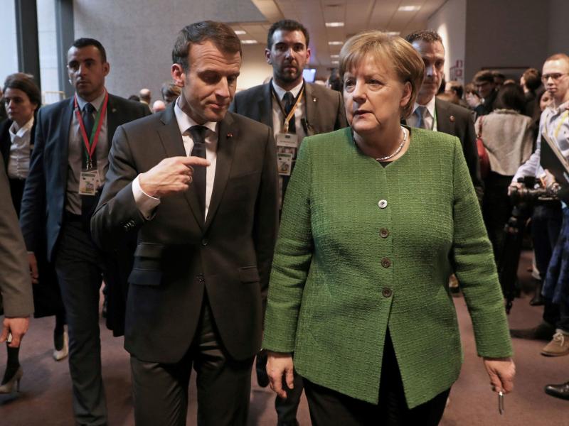 French President Emmanuel Macron speaks with German Chancellor Angela Merkel in Brussels last month. French President Emmanuel Macron speaks with German Chancellor Angela Merkel in Brussels last month.