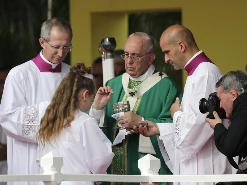 Pope Francis gives Communion at the end of the first mass of his visit to Cuba in Havana's Revolution Square, on Sunday. Pope Francis gives Communion at the end of the first mass of his visit to Cuba in Havana's Revolution Square, on Sunday.