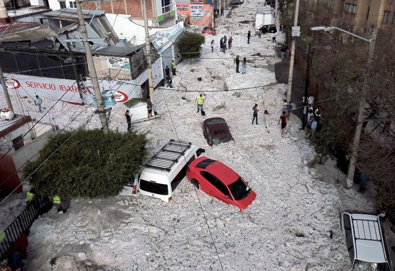 Vehicles were buried in hail on Sunday in eastern Guadalajara, Jalisco state, Mexico. The accumulation of hail buried vehicles and damaged homes. Vehicles were buried in hail on Sunday in eastern Guadalajara, Jalisco state, Mexico. The accumulation of hail buried vehicles and damaged homes.