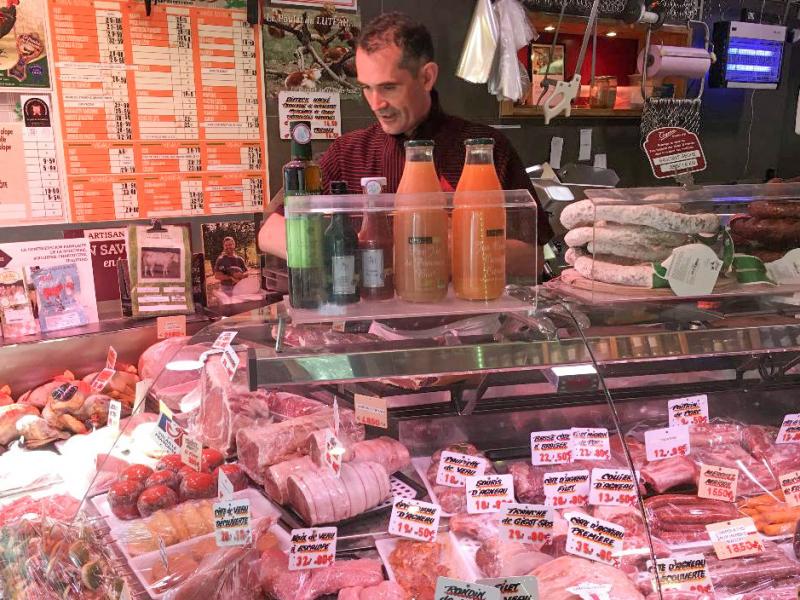 Didier Tass, behind the counter of his butcher shop, says he purchases meat from small farmers who raise cows and butcher them humanely and in small quantities. Didier Tass, behind the counter of his butcher shop, says he purchases meat from small farmers who raise cows and butcher them humanely and in small quantities.