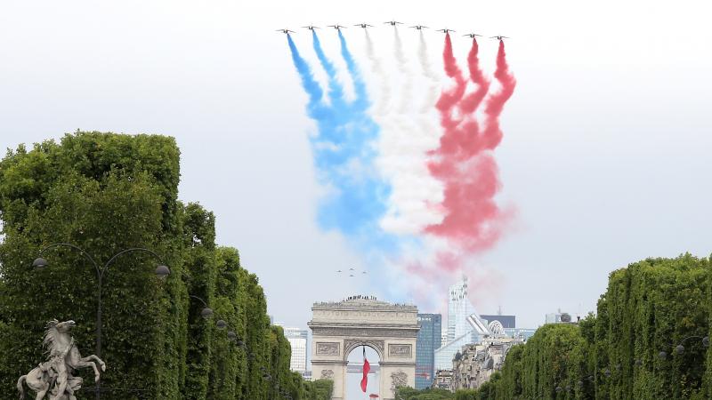 The French elite acrobatic flying team Patrouille de France performs a flying display of the French national flag over the Arc de Triomphe during the annual Bastille Day military ceremony in Paris on Tuesday. The French elite acrobatic flying team Patrouille de France performs a flying display of the French national flag over the Arc de Triomphe during the annual Bastille Day military ceremony in Paris on Tuesday.