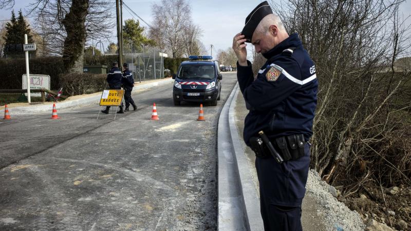 A French gendarme stands guard Wednesday in Avallon after thieves attacked two armored vans carrying jewels overnight. A French gendarme stands guard Wednesday in Avallon after thieves attacked two armored vans carrying jewels overnight.