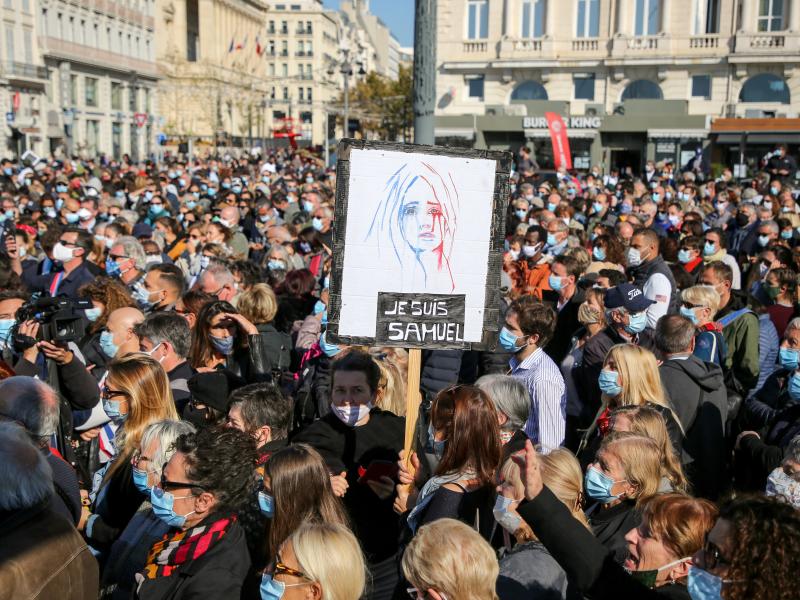 Demonstrators wearing face masks gather Sunday in Marseille, France, to pay tribute to teacher Samuel Paty, who was beheaded after he showed his class cartoons depicting the Prophet Muhammad. Demonstrators wearing face masks gather Sunday in Marseille, France, to pay tribute to teacher Samuel Paty, who was beheaded after he showed his class cartoons depicting the Prophet Muhammad.