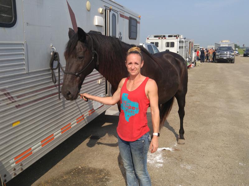 Amy Walters from Copperas Cove, Texas, with a horse she rode as she rounded up lost cattle and brought them to the makeshift shelter in Beaumont, Texas. Amy Walters from Copperas Cove, Texas, with a horse she rode as she rounded up lost cattle and brought them to the makeshift shelter in Beaumont, Texas.