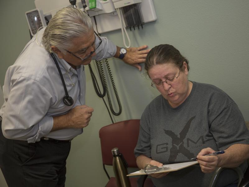 Dr. Ronald Cirillo helps Deborah Hatfield fill out paperwork at a Florida clinic, before running a test to see whether she has hepatitis C. Dr. Ronald Cirillo helps Deborah Hatfield fill out paperwork at a Florida clinic, before running a test to see whether she has hepatitis C.
