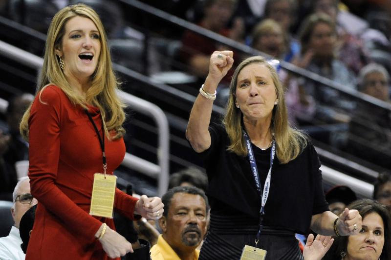 Kelly Loeffler (left), with Mary Brock, cheers the Atlanta Dream on courtside during a 2011 game. Now a senator, Loeffler faces a political challenge over her stake in the WNBA franchise in a tough election race. Kelly Loeffler (left), with Mary Brock, cheers the Atlanta Dream on courtside during a 2011 game. Now a senator, Loeffler faces a political challenge over her stake in the WNBA franchise in a tough election race.
