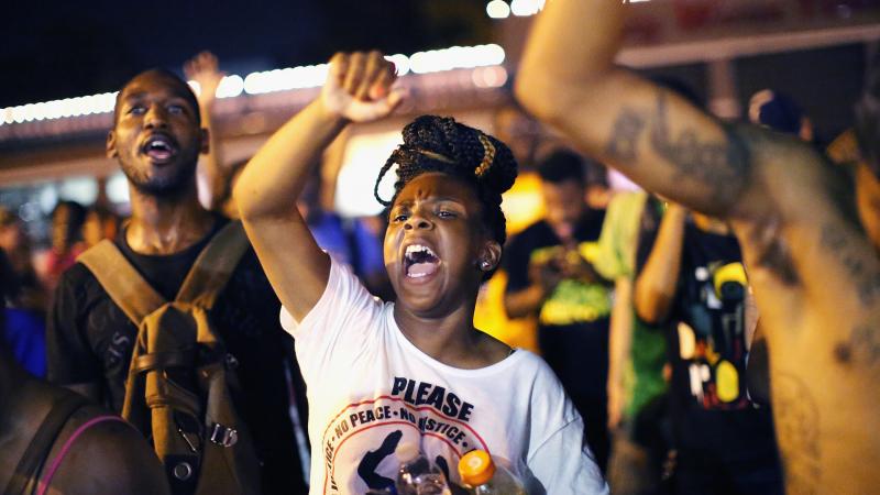 Demonstrators protest the death of Michael Brown on Friday in Ferguson, Mo. Brown was shot and killed by a Ferguson police officer on August 9. Demonstrators protest the death of Michael Brown on Friday in Ferguson, Mo. Brown was shot and killed by a Ferguson police officer on August 9.