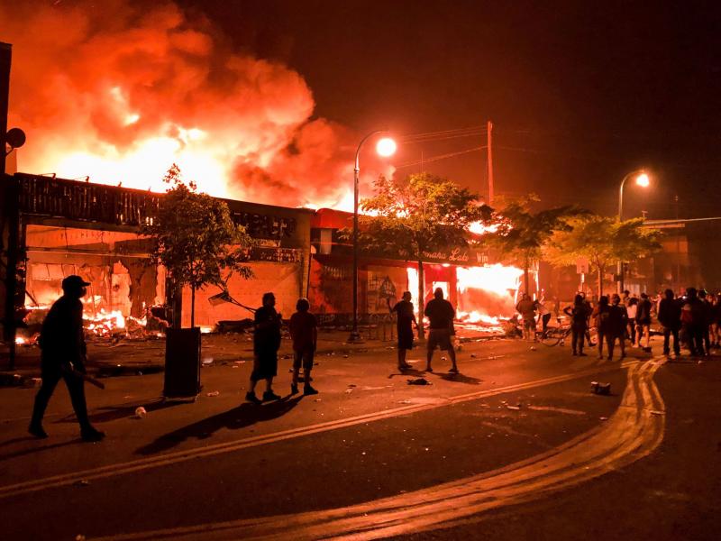 Flames rise from a liquor store and shops near the 3rd Police Precinct in Minneapolis on Thursday , during a protest over the death of George Floyd. Flames rise from a liquor store and shops near the 3rd Police Precinct in Minneapolis on Thursday , during a protest over the death of George Floyd.